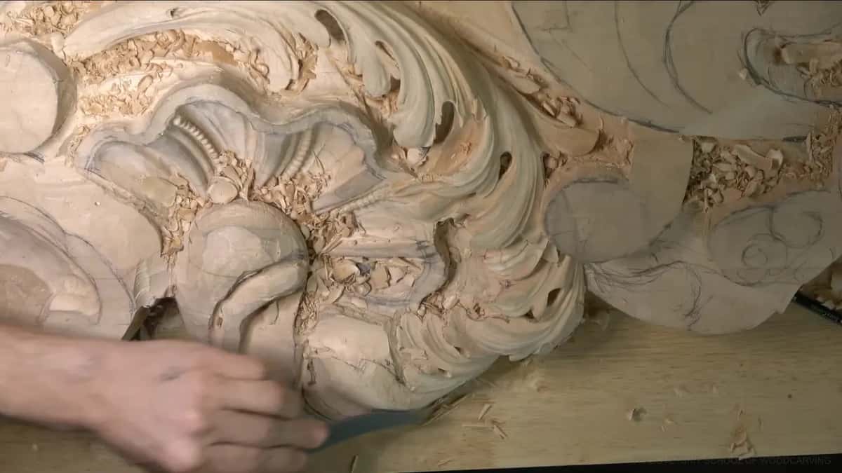 From the side, a blue tool rides the lower curve of the head.
