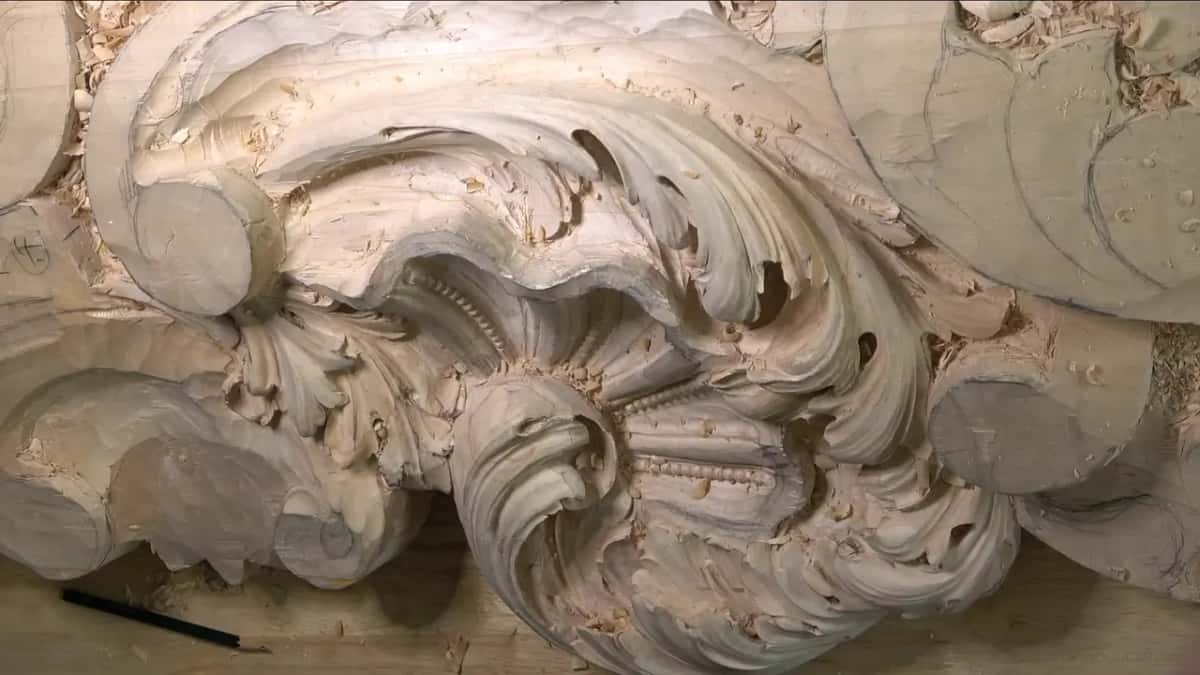 Pencil resting below the carving.