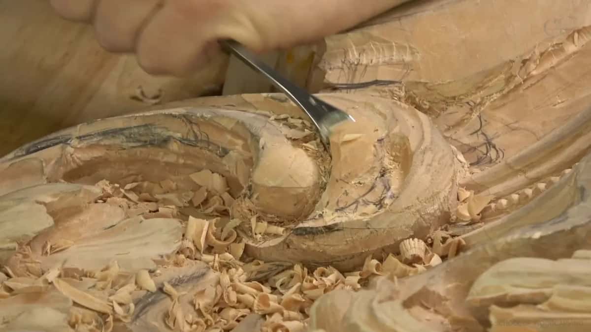 Chips pile up as a bent gouge cuts.