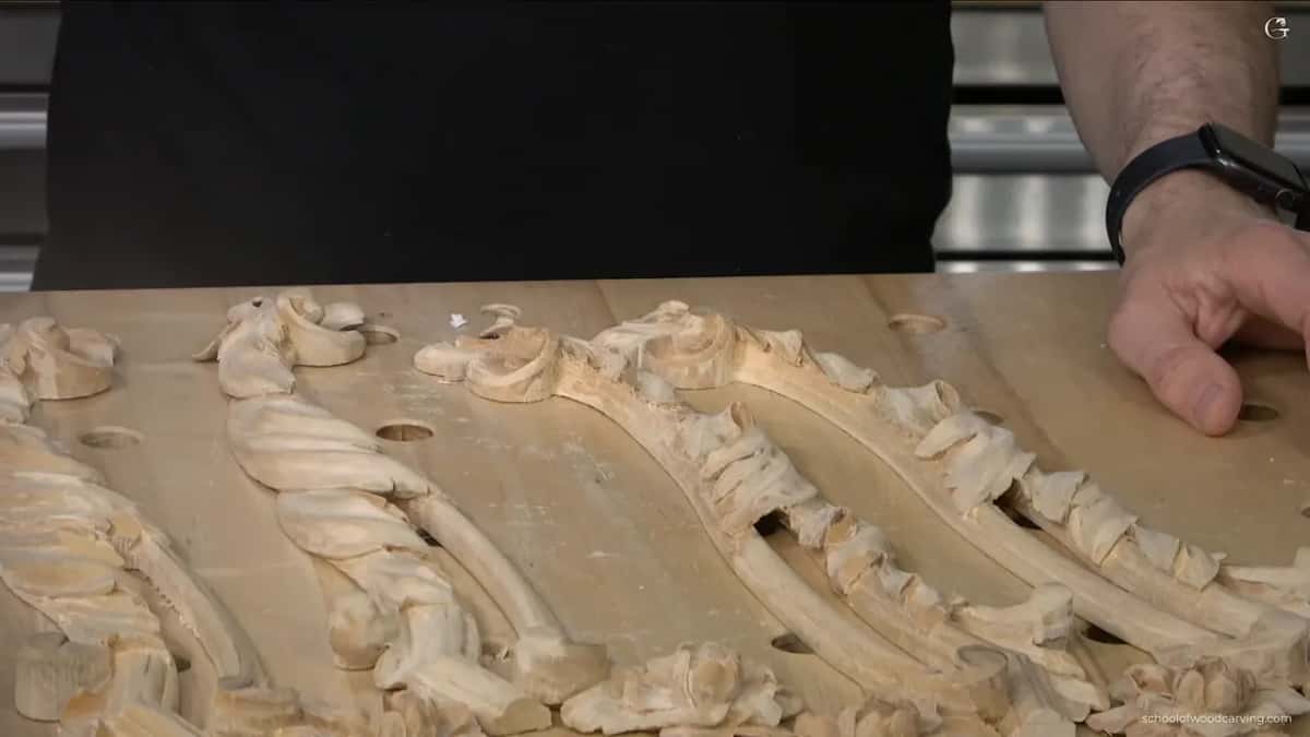 Four carved pieces laid out together on the bench