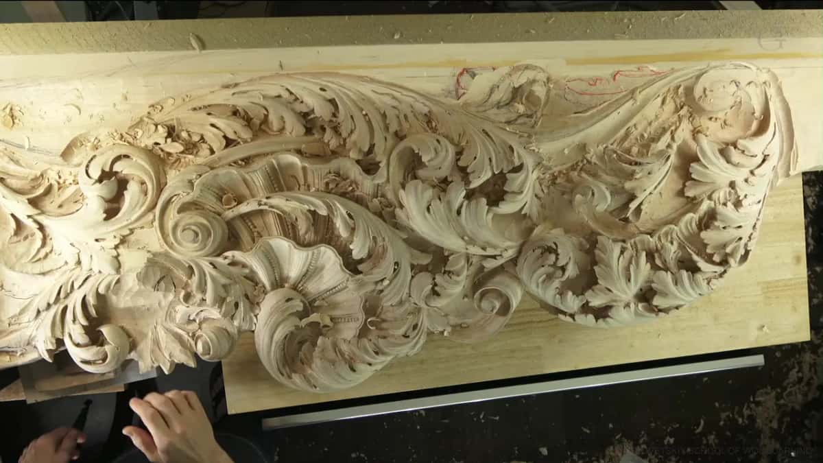 The long acanthus panel from overhead, one end still only pencil and red marks.