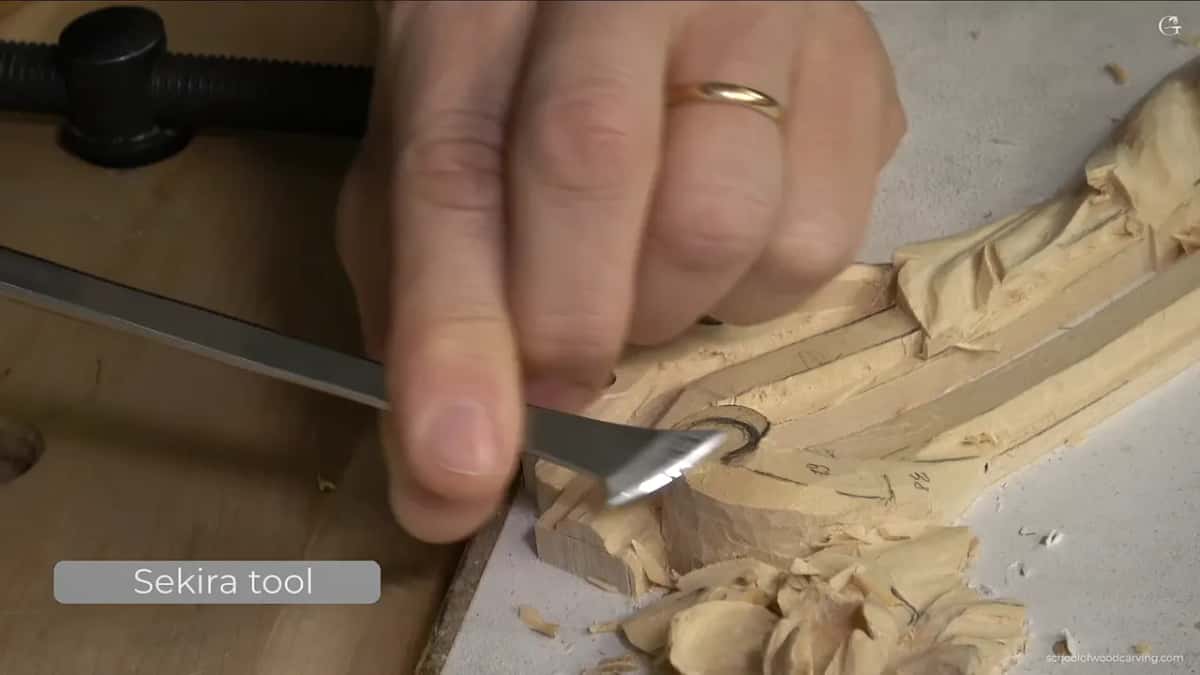 Blade in hand over the panel. This one keeps slicing after the grain turns against it.
