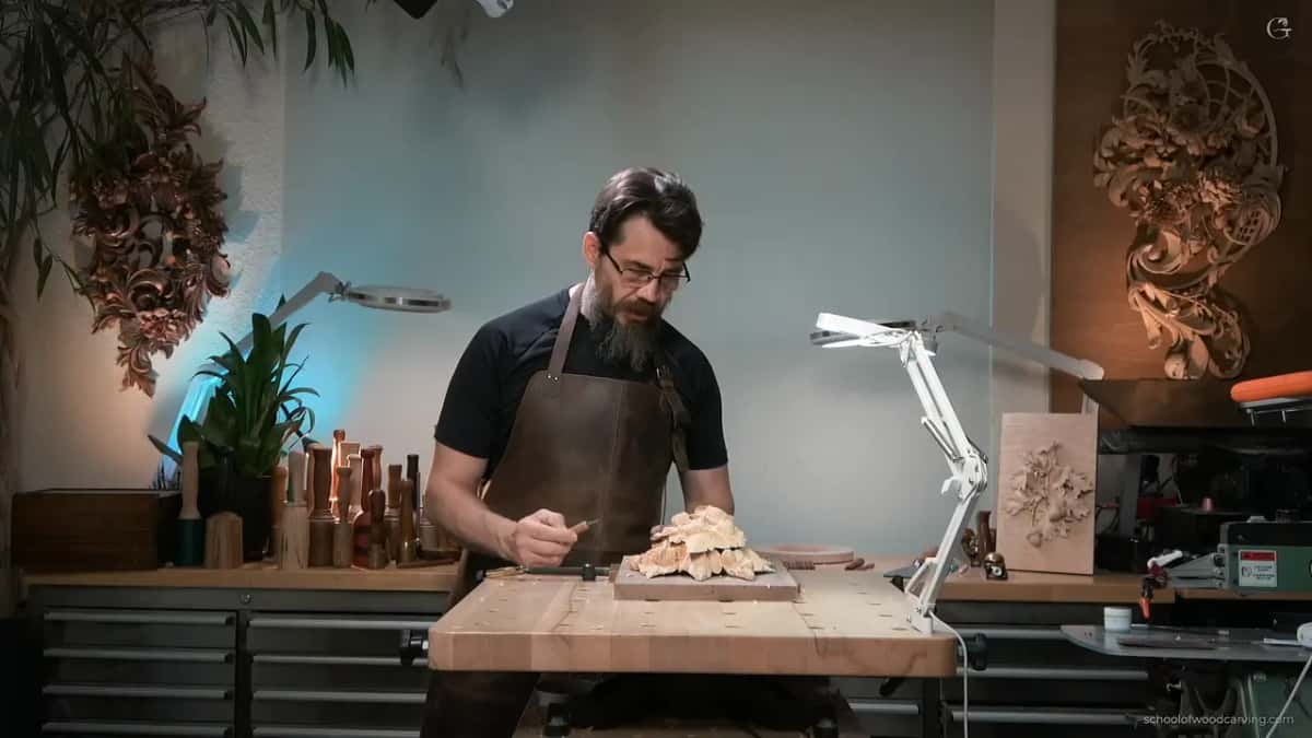 Head down over the panel, knife in hand