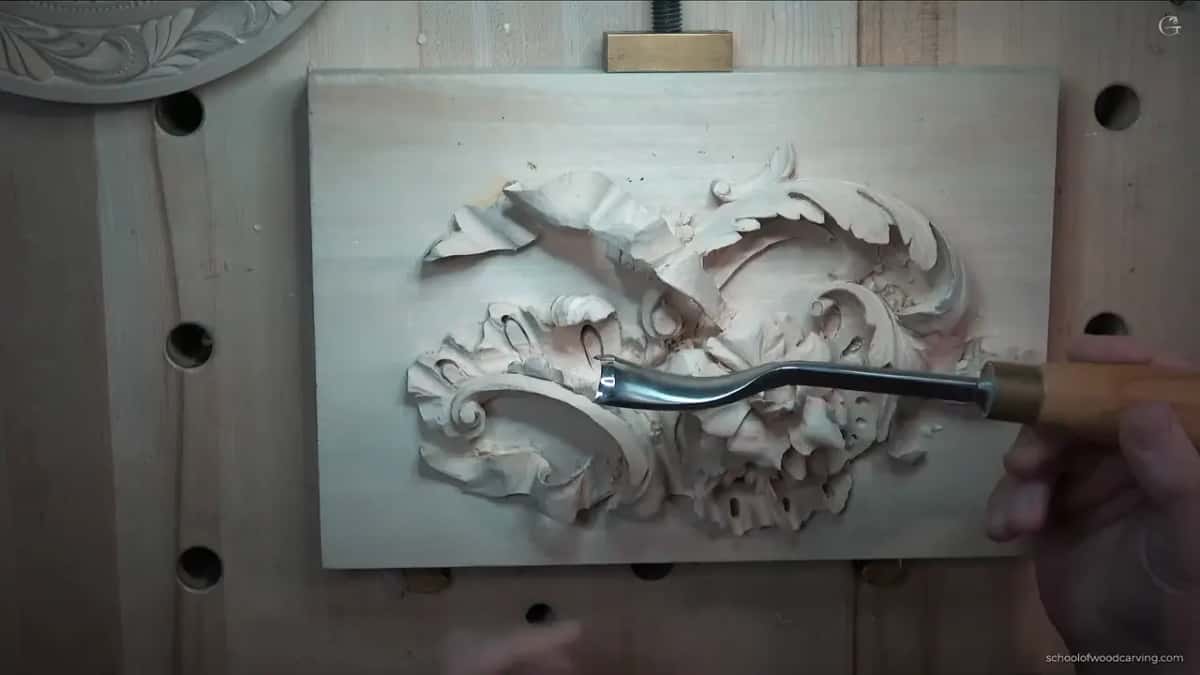 Curve of the blade seen clearly against the pale wood.