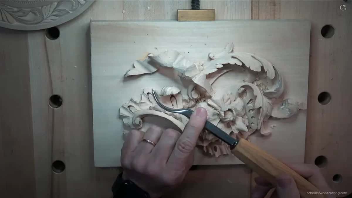 Cutting in beneath a carved lip, exactly the undercut no straight tool could reach.