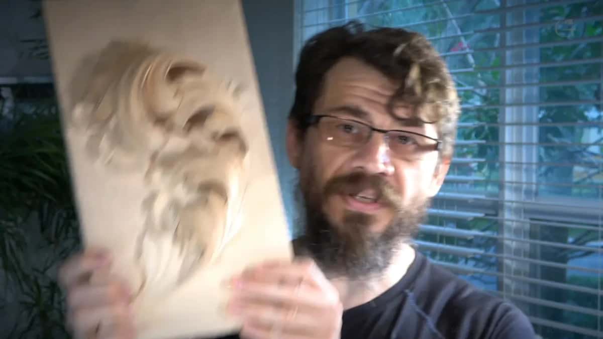 Byzantine acanthus leaf part carved in pale wood, held up to the camera, deliberately unfinished.