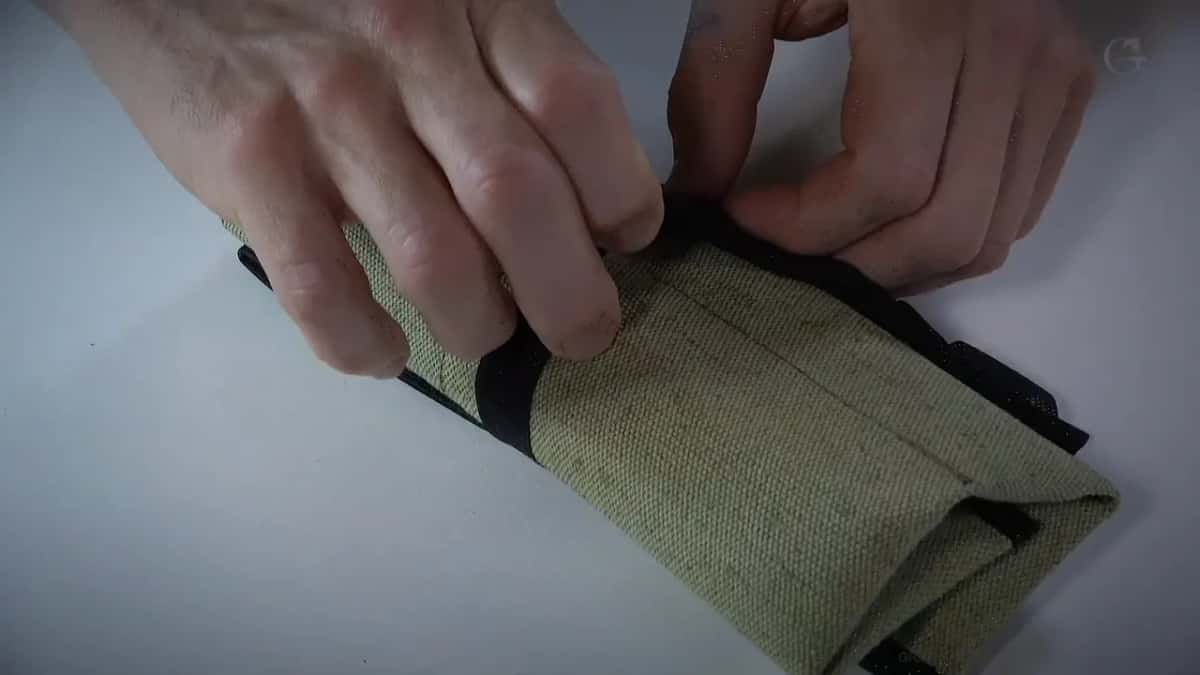 Two hands folding the roll open.