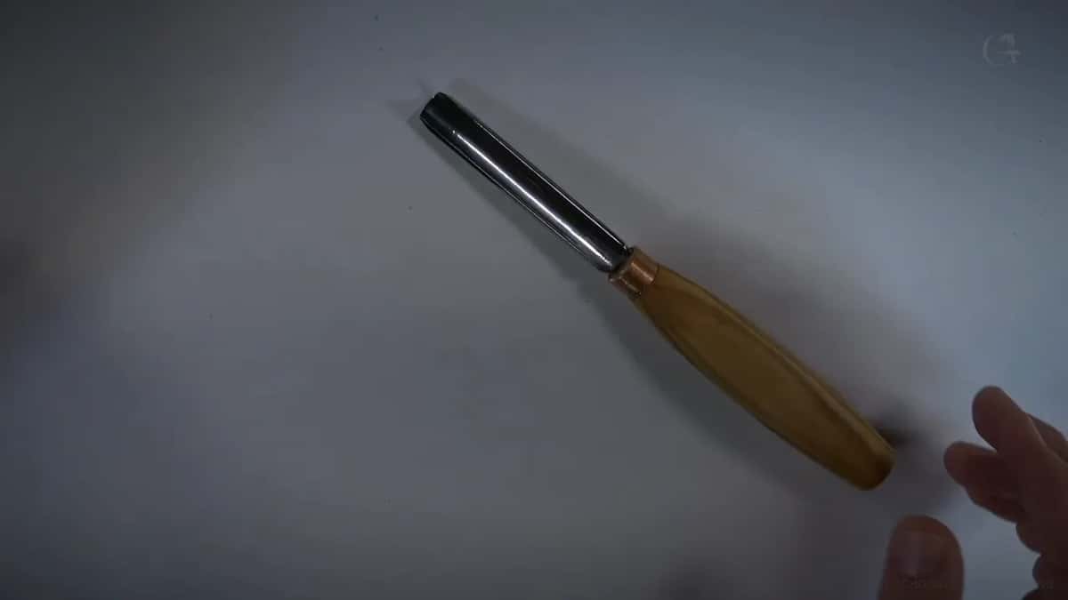 Small straight gouge resting on white.
