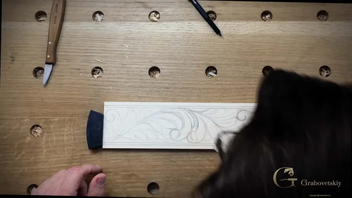 Board carrying the drawn design, knife laid beside it