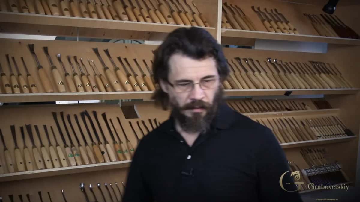 Rack after rack of gouges filling the wall behind him
