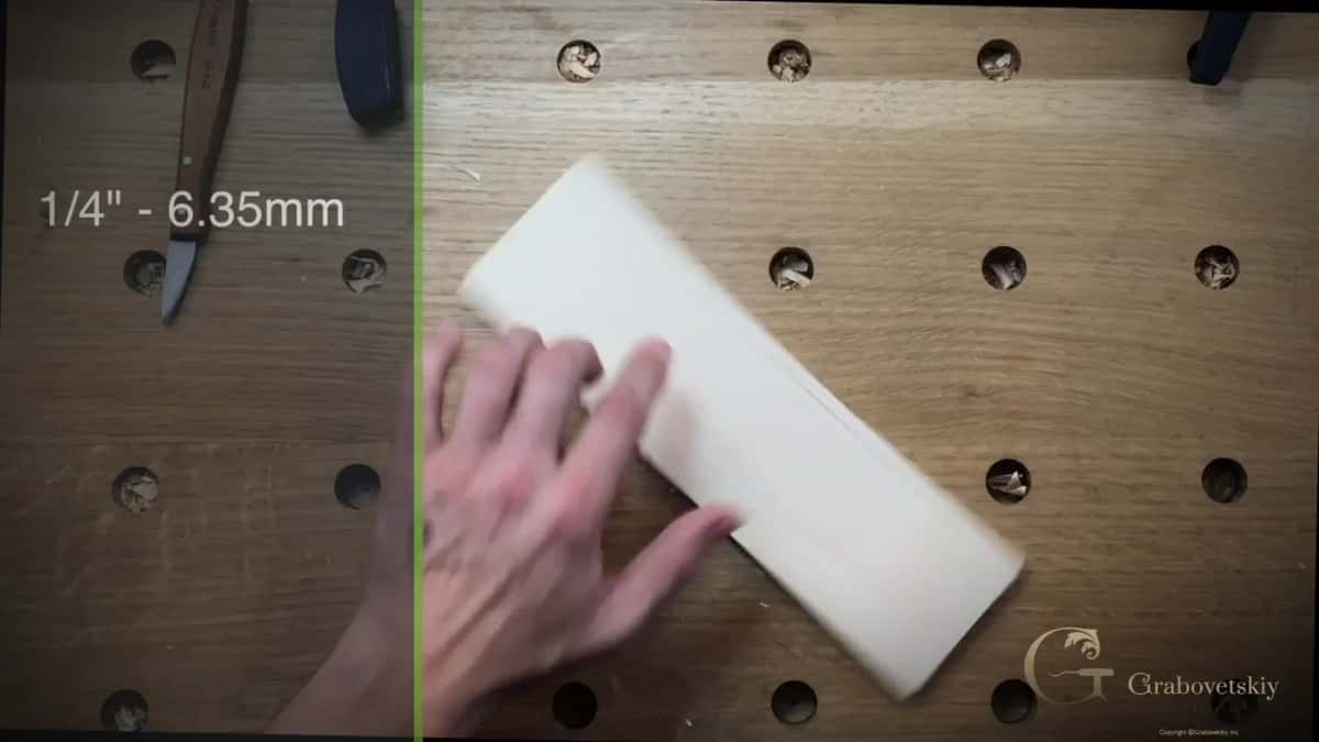 Quarter inch captioned on screen as six point three five millimetres, the boundary drawn down the board