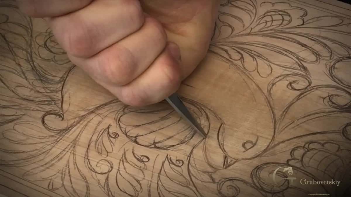 Fist grip, blade coming in low so the wall slopes instead of dropping.