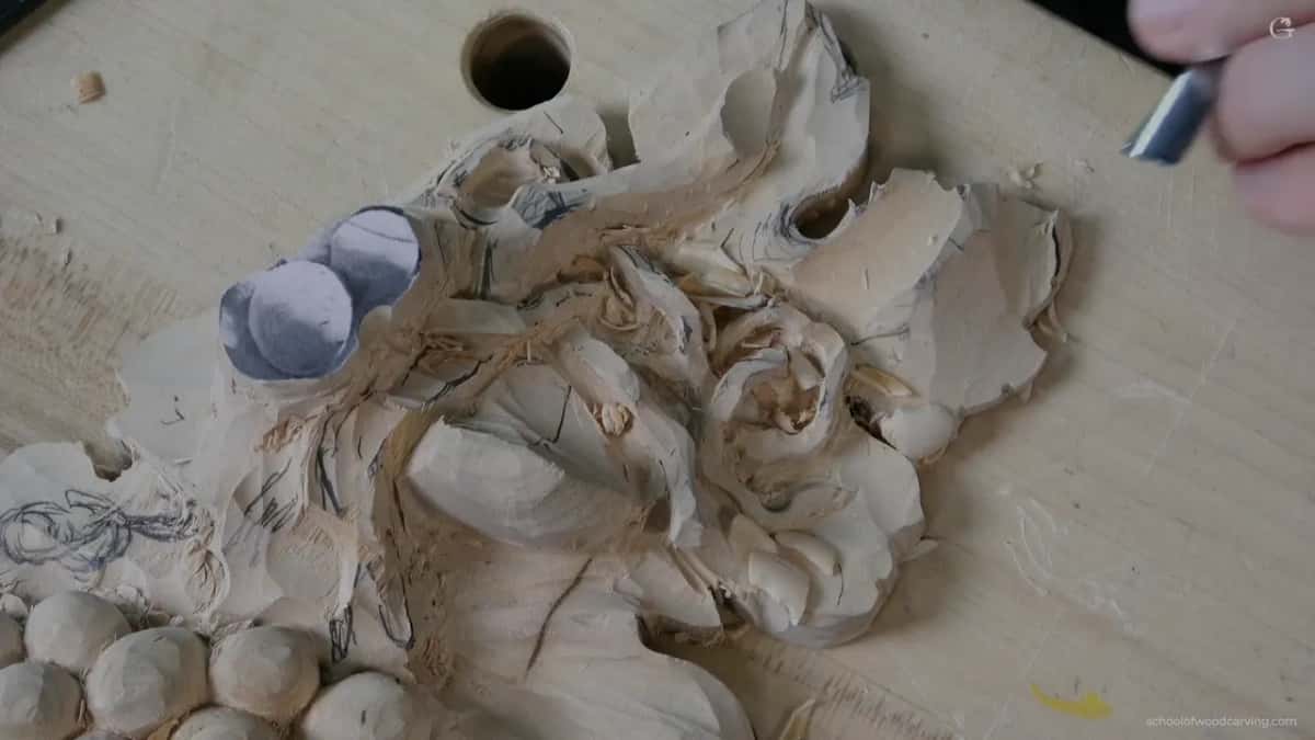 Carving along the grain on a thin edge, where a dull tool would take the lobe off