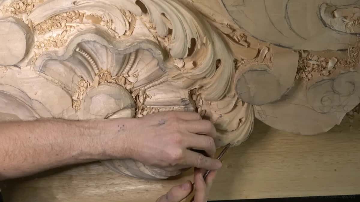 Forearm across the shell, blade in the leaf center.