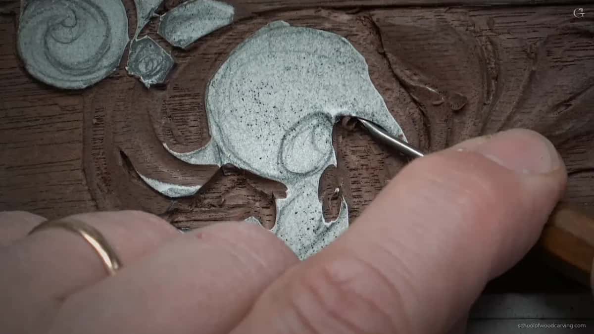 Wedding ring visible as the small tool goes back in.