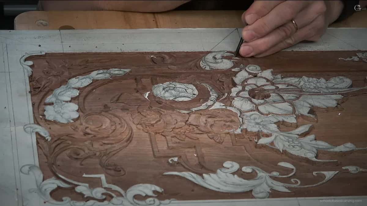 Overhead shot, both hands at work on the lower half of the panel while the top stays untouched.