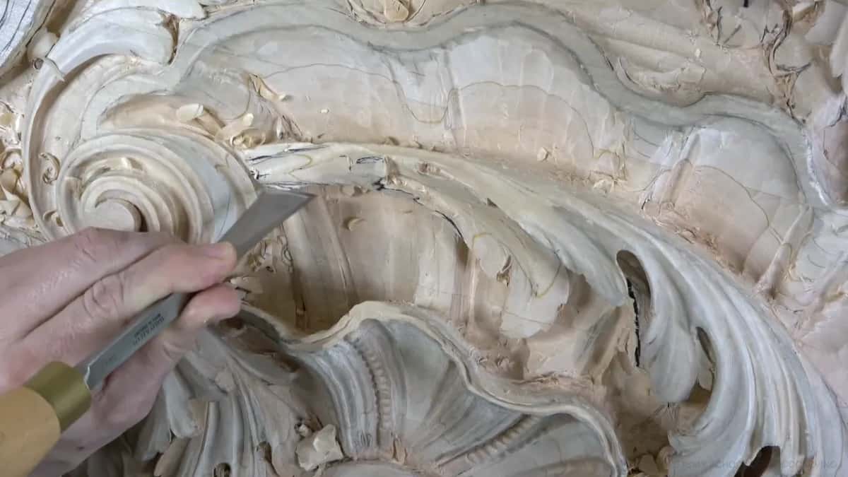 Brass ferrule and a wide blade, slicing into the hollow above the shell.