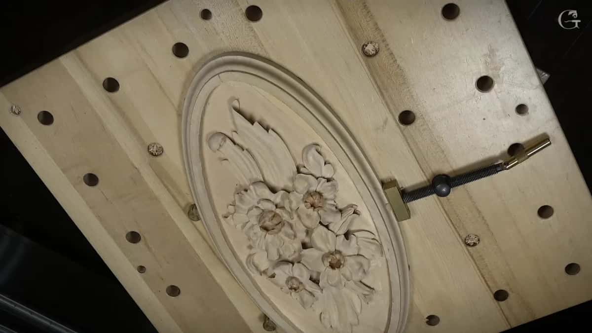 That rosette turned sideways under a clamp with a brass end