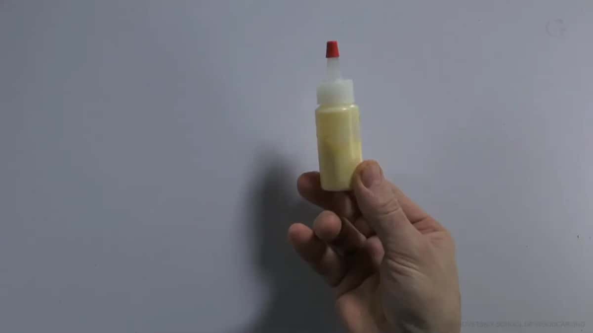 Small squeeze bottle of yellow glue