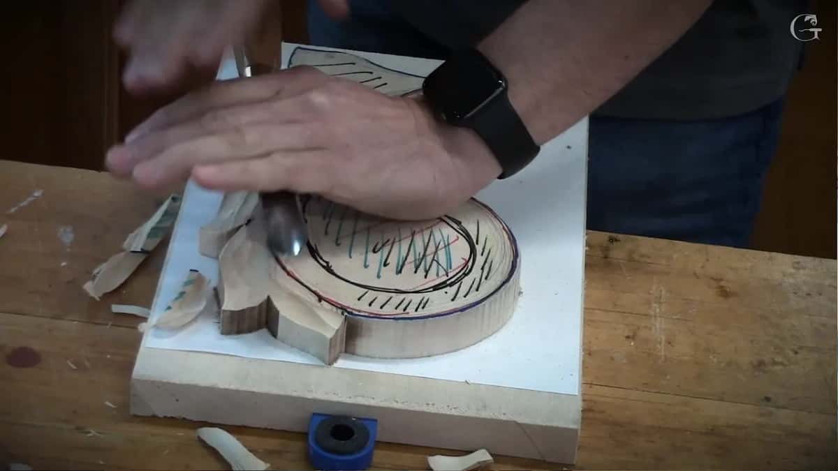 Both hands on the tool, the left one lying flat along the blade