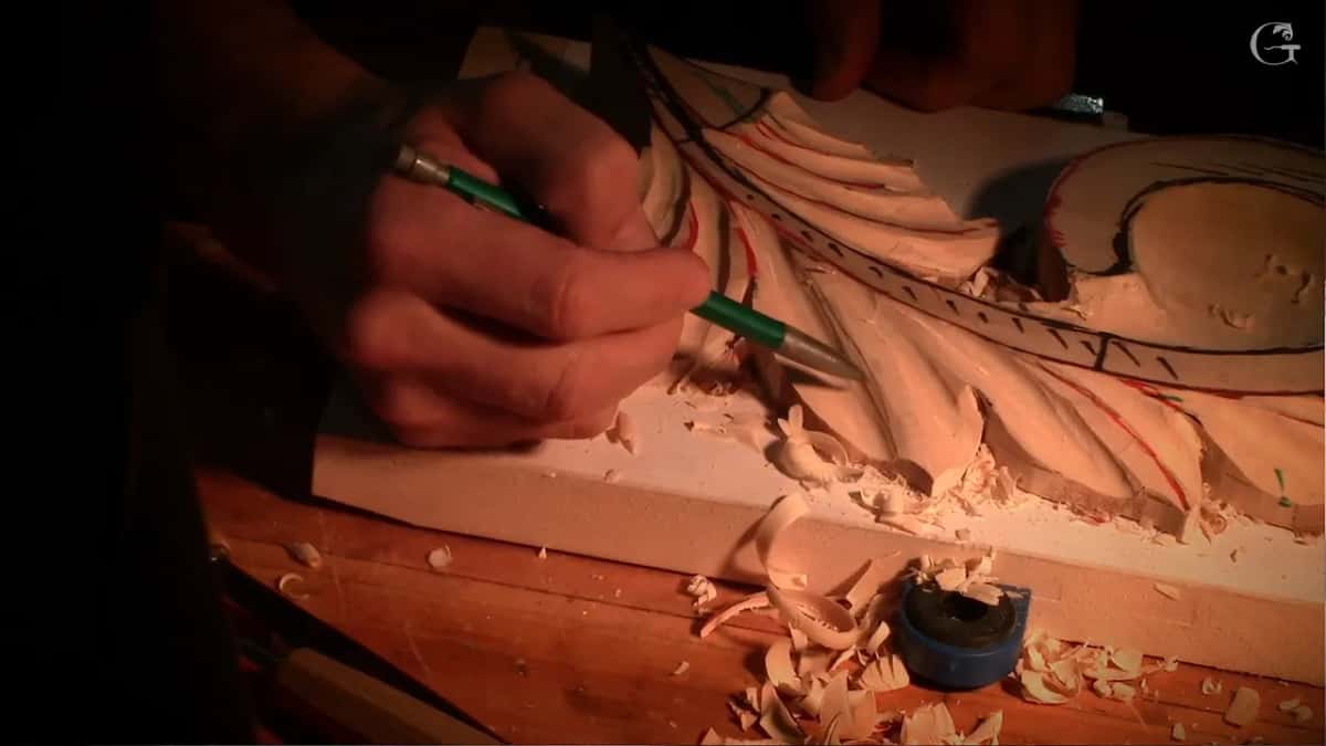 Pen in hand above the modelled leaves, checking a line that looks too straight