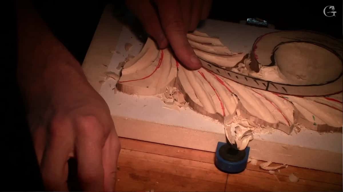 Both hands beside the piece between cuts