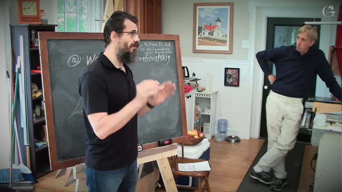 Standing at the board, hands together, going through the reason none of this carries channels