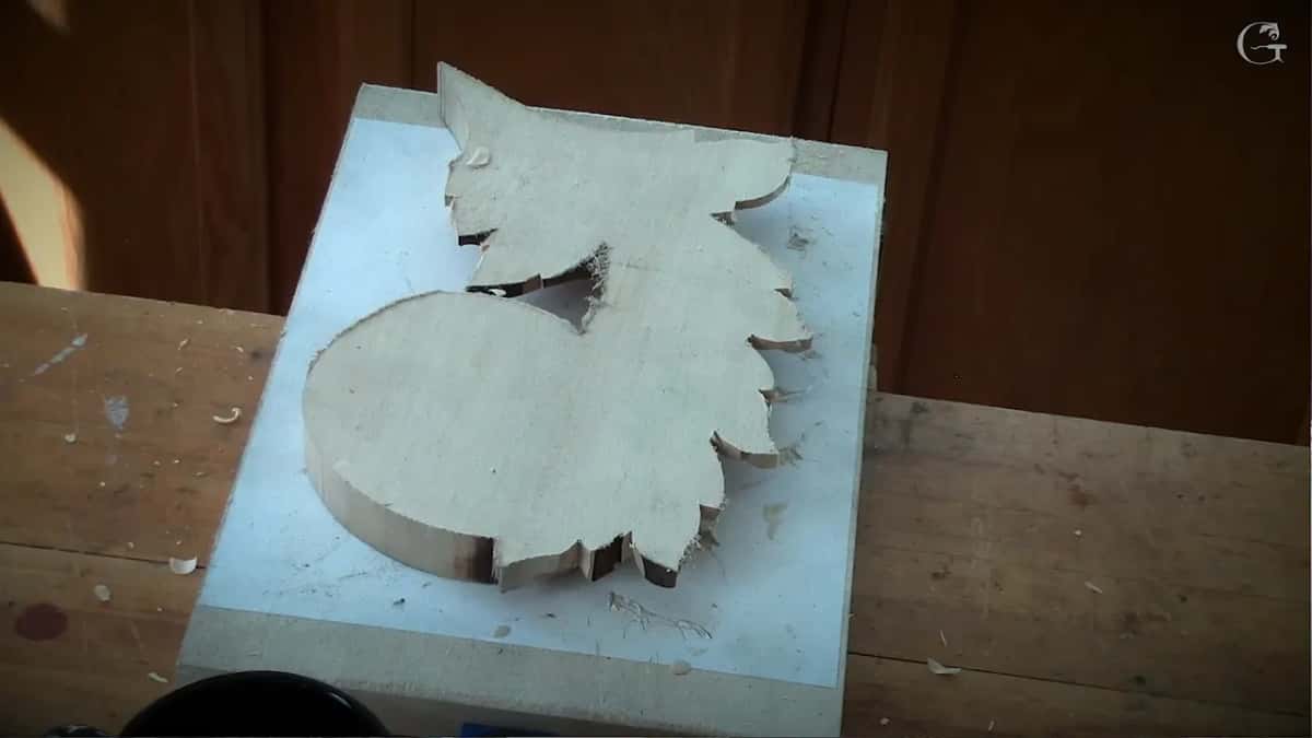Piece face down on its white board, the reverse still bare