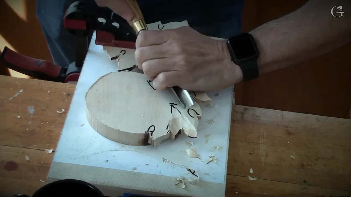 Gouge cutting beside an arrow, well away from the centre where the front would meet it