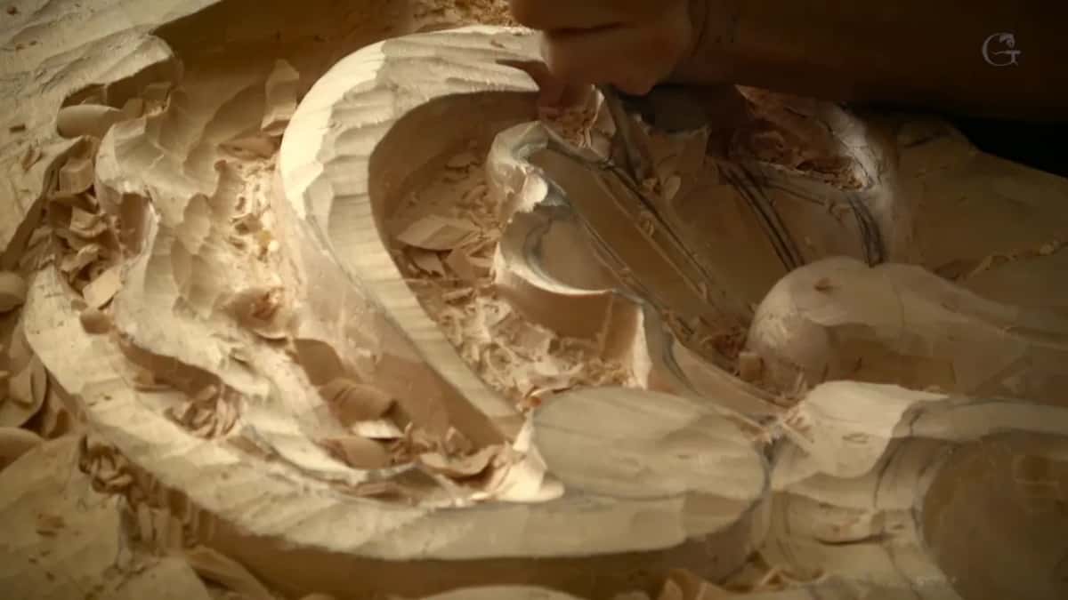 Low warm light fills a deep hollow crowded with chips near the rim