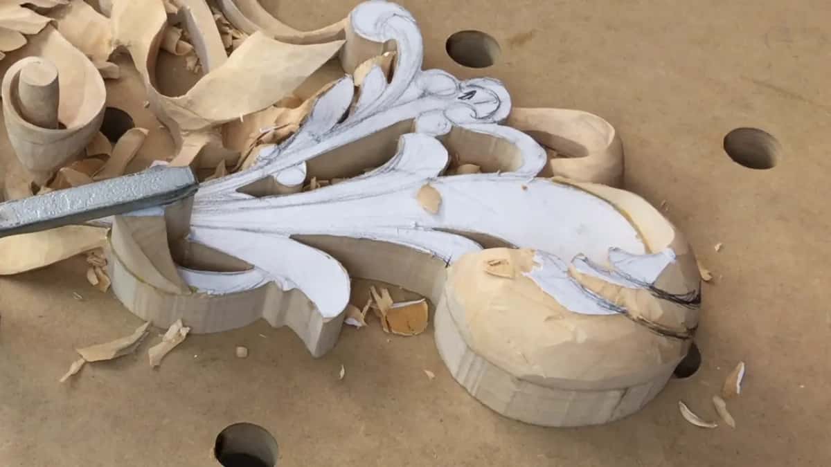 White paint over most of the leaf, bare rounded wood at the claw end, an L-shaped hold-down at left