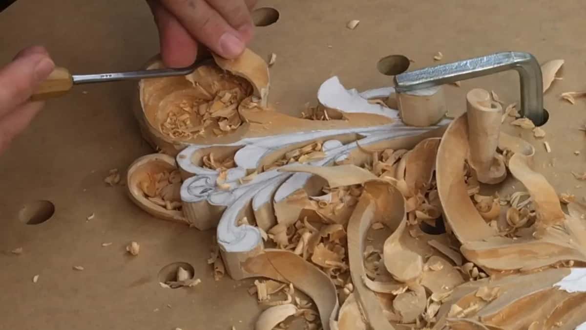 Fingers on a pale handle, top of the curl