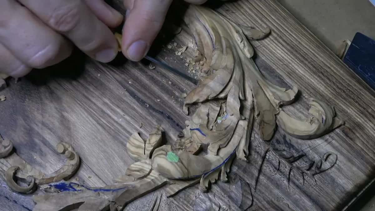 Tiny tool pinched in the fingertips near the top lobes