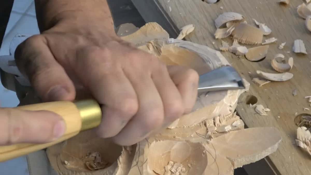 Gouge sweeping outward, shavings everywhere