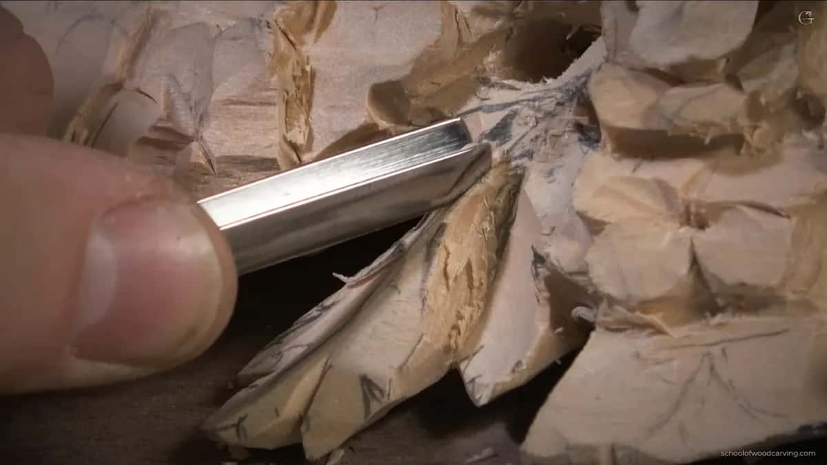 Steel resting on the thumb, the edge easing out of the cut