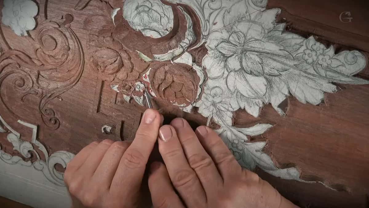 Low on the board, a slim tool held between the fingers
