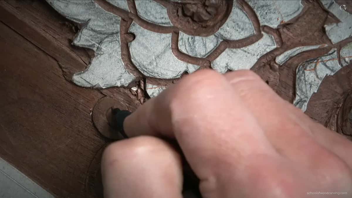 Something dark held against the carving where the spiral needed to run a further round than drawn.
