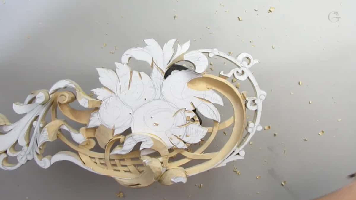 Whole carving in view, leaves above and lattice below, none of it near finished
