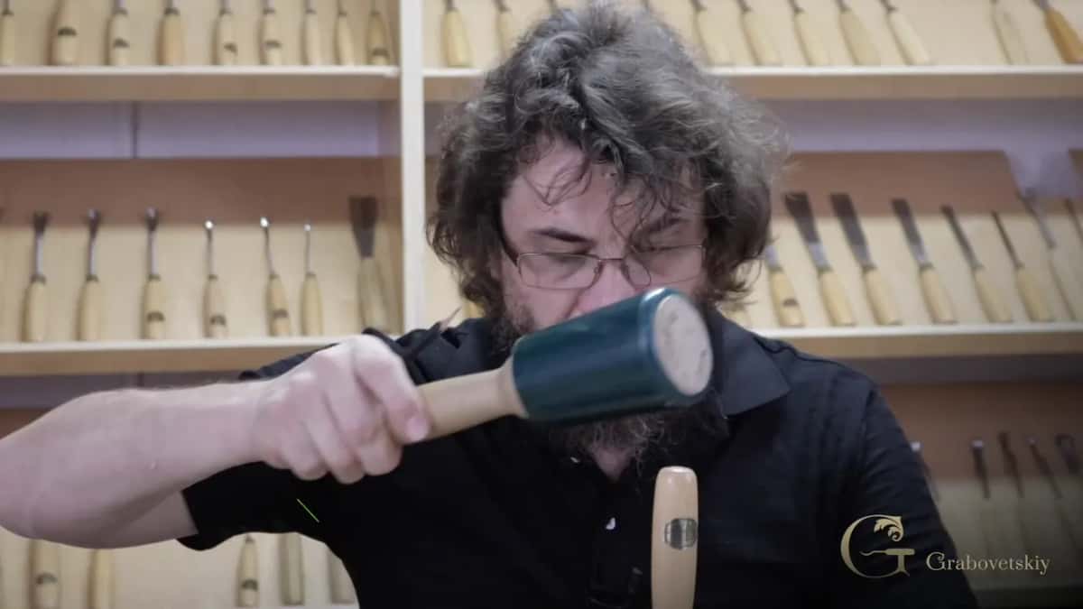Mallet in one hand, gouge in the other