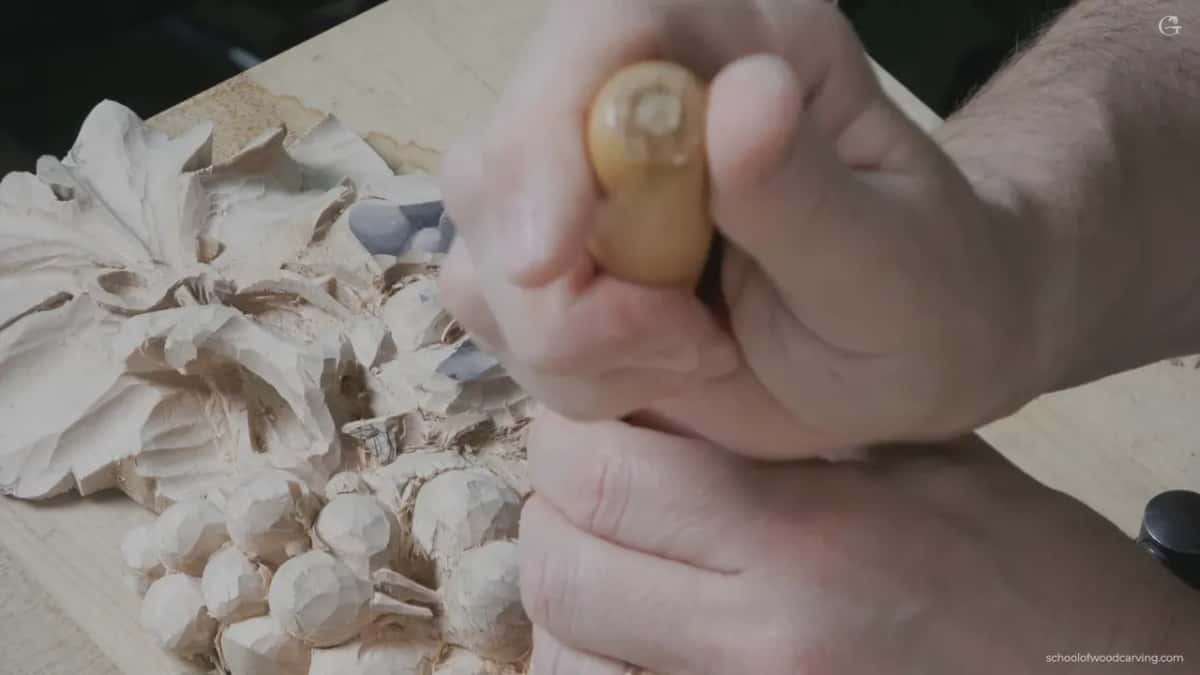 Amber handled gouge held upright in the fist