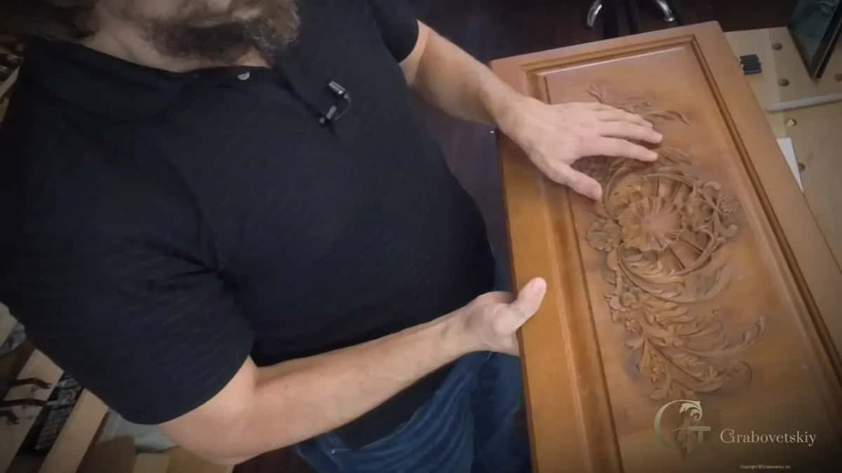 A deep relief panel held up, acanthus down one side