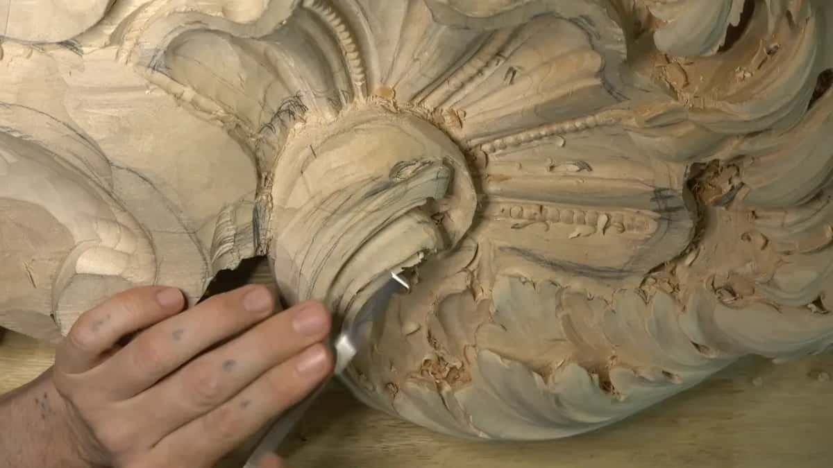 A gouge rides inside the lower part of the curl while one hand steers it.