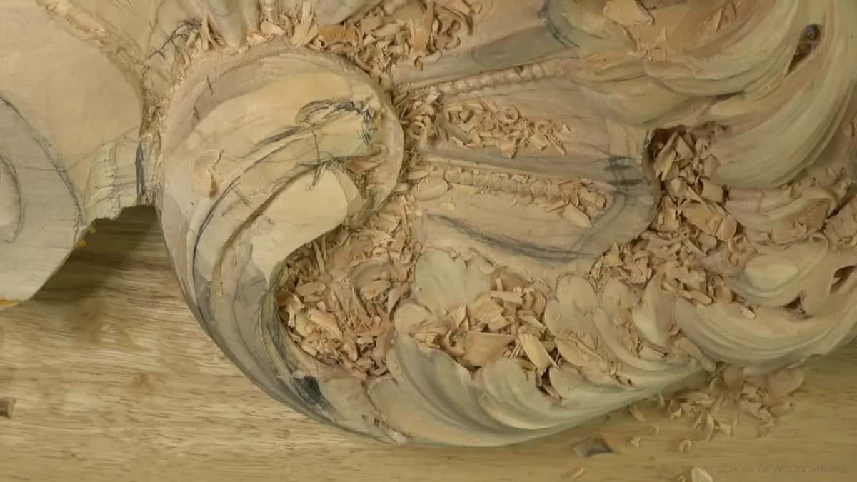 Lime acanthus head on the bench, a big curl beside a beaded shell.