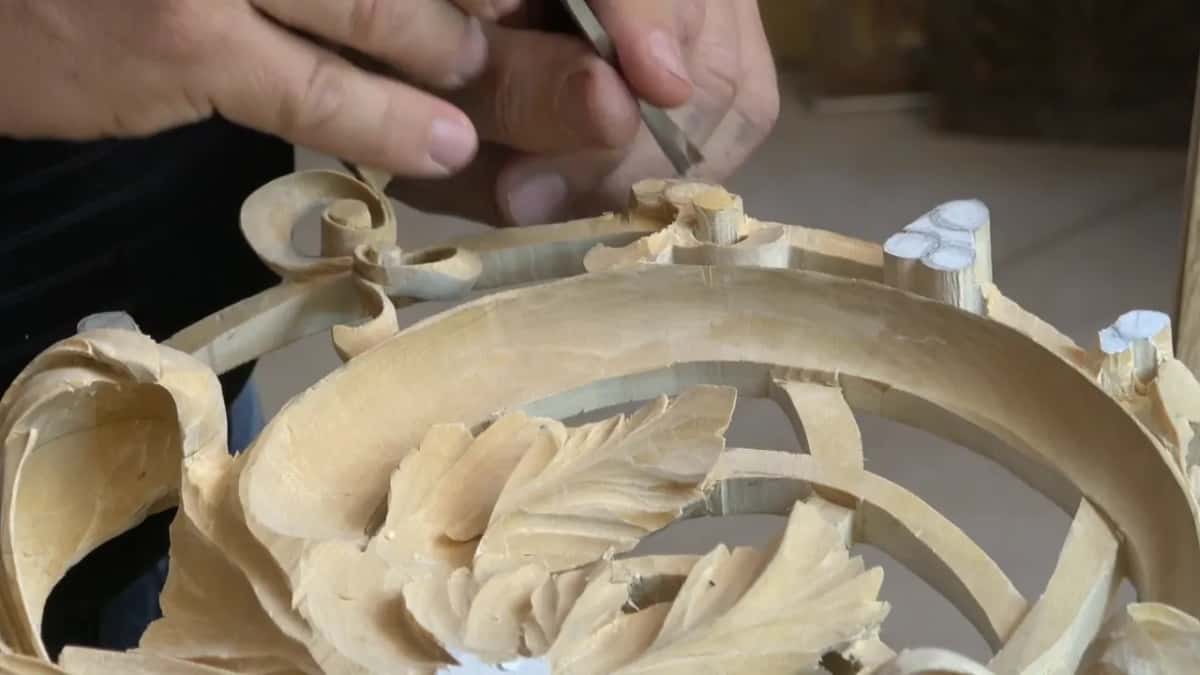 From the same high angle my hands hover above the frame, a tool held near a curl at the top
