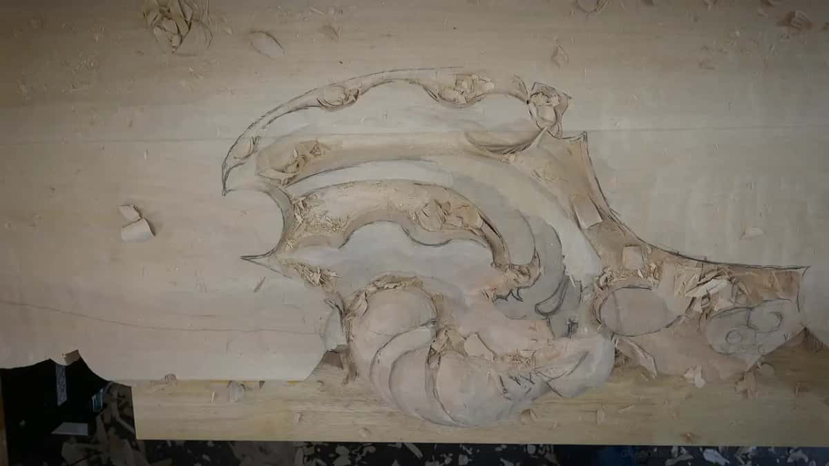 The whole roughed panel seen from above, with chips still lying in the hollows around the ribbed shell.