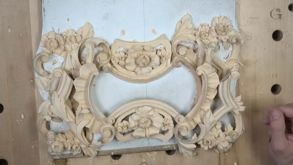 Both pieces side by side, mirrored, flowers and scrolls closing into one frame