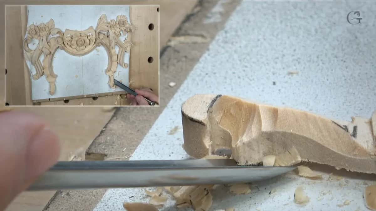 Reaching under a carved edge with a gouge, seen low and close