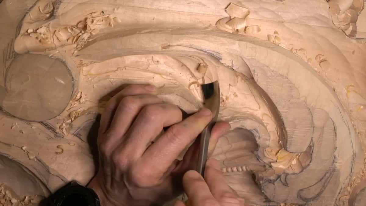 Bent blade drawn back toward the camera, beads below.