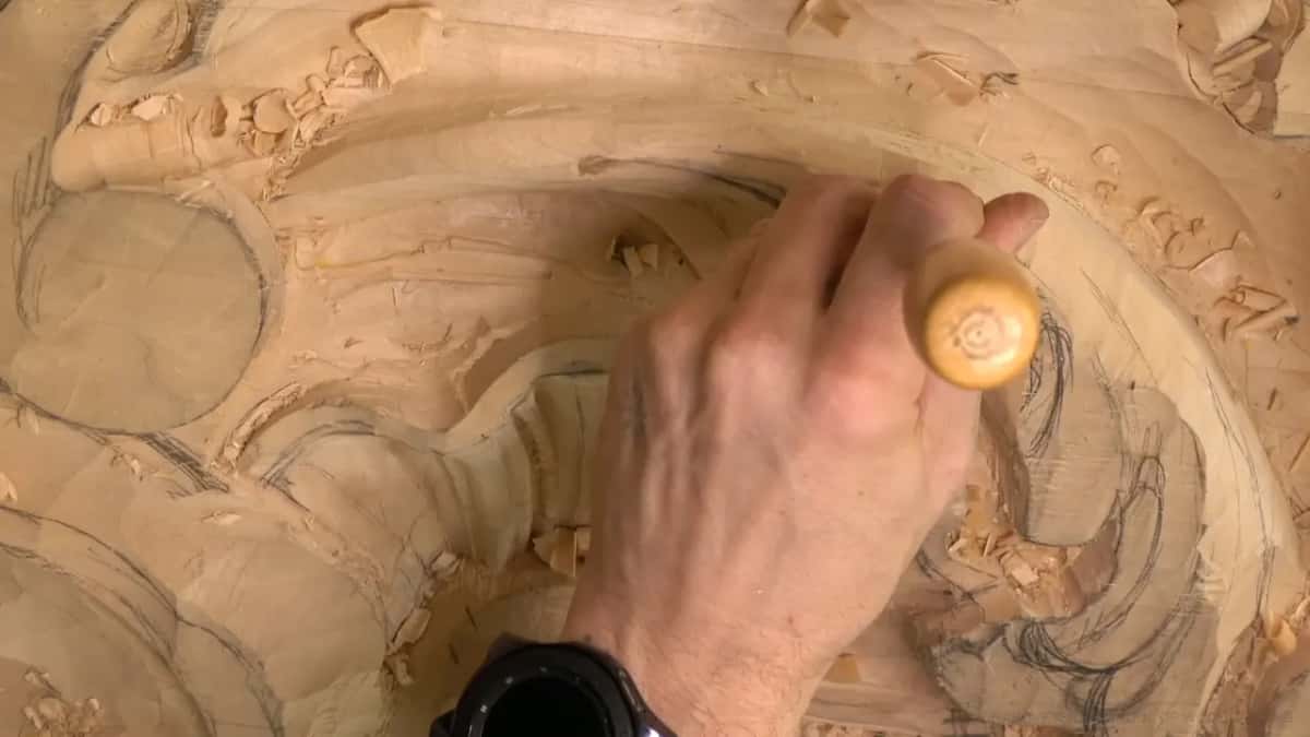 Pencil scrolls wait on the right while a round ended handle drives in.