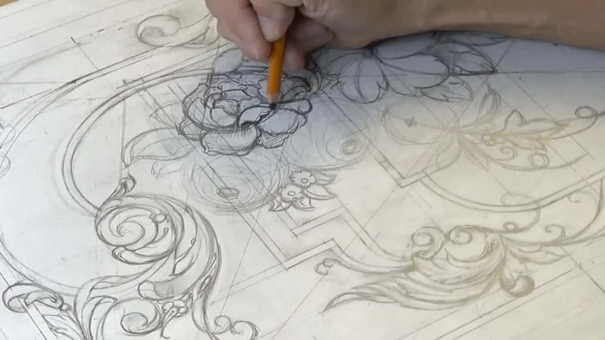 An orange pencil lays the first shadow into a drawn rose while the rest of the panel stays pale line work